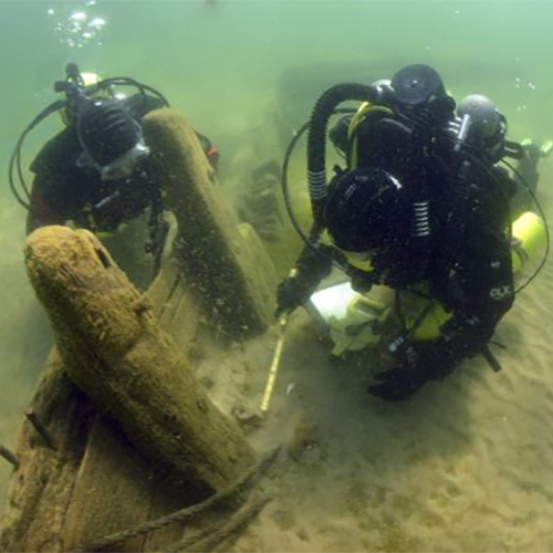 Two scuba divers exploring a wreck